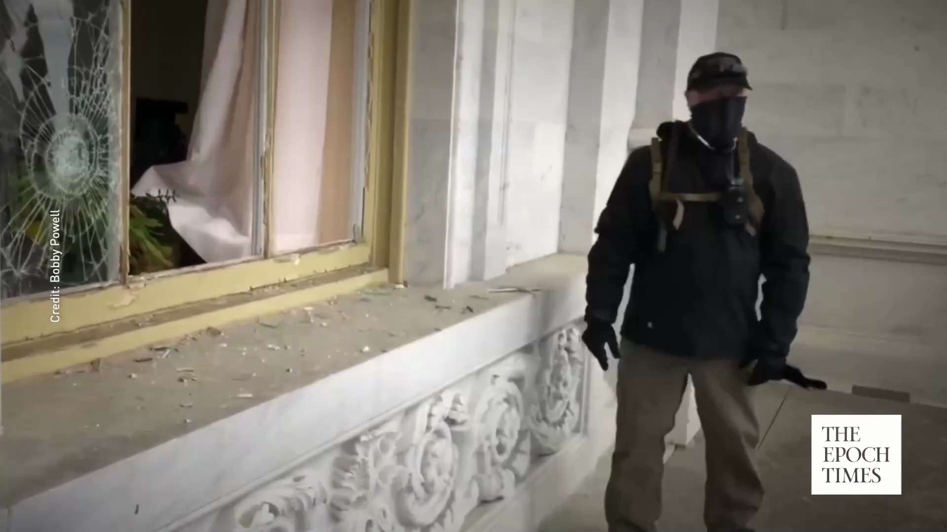 On Jan. 6th, a masked man wearing an earpiece and walkie-talkie was caught on video removing a glass...