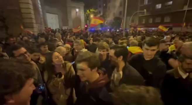 A Spanish man shows off his Tucker Carlson t-shirt as Tucker shakes hands and greets throngs of Madr...