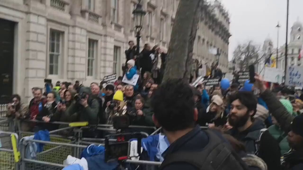 NOW - NHS staff are throwing their uniforms in protest of the vaccine mandate at the police outside Downing Street.