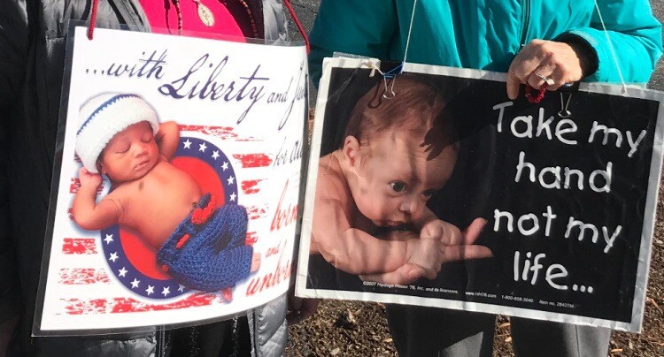 Last week, a mom went to Planned Parenthood for an abortion, accompanied by her children.
One of the kids saw this sign a pro-life person was holding and