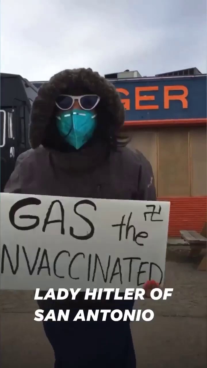 AOC supporters hold up a sign that says, " gas the unvaccinated."