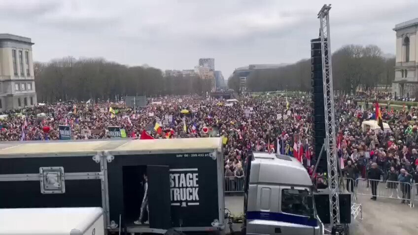 Around the corner, tens of thousands pack into the square in protest against covid passports and man...