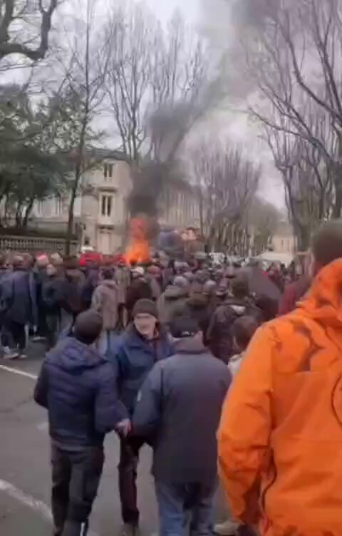 French farmers protesting against rising gas prices destroying their livelihoods, dump and burn farm rubbish outside government buildings.