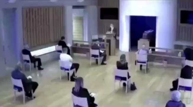 Sons attempt to comfort their mother at their fathers funeral, only to be pulled away, and the peopl...