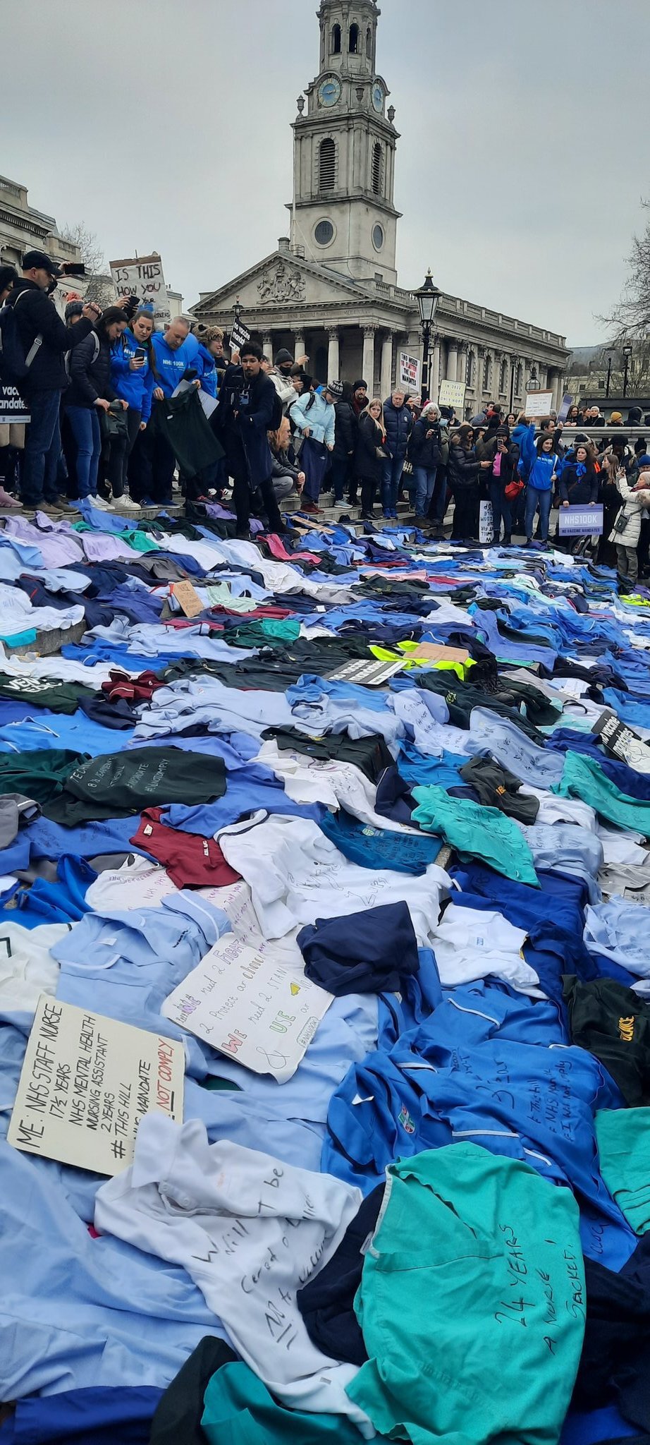 NHS staff from all over the UK laying their uniforms on the steps of Trafalgar Square right now as the deadline for the vaccine mandate draws closer.