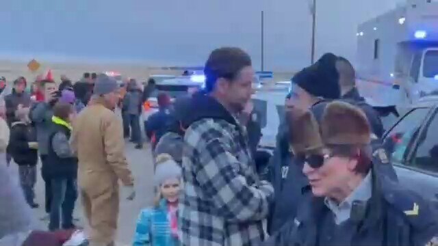 Day 18 of the Coutts border blockade, police and protesters hug, shake hands and sing the national a...