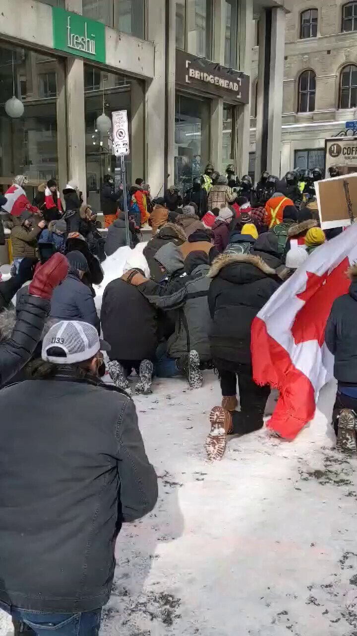 Ottawa protesters kneel in prayer as lines of riot units face off with them.
https://www.facebook.co...