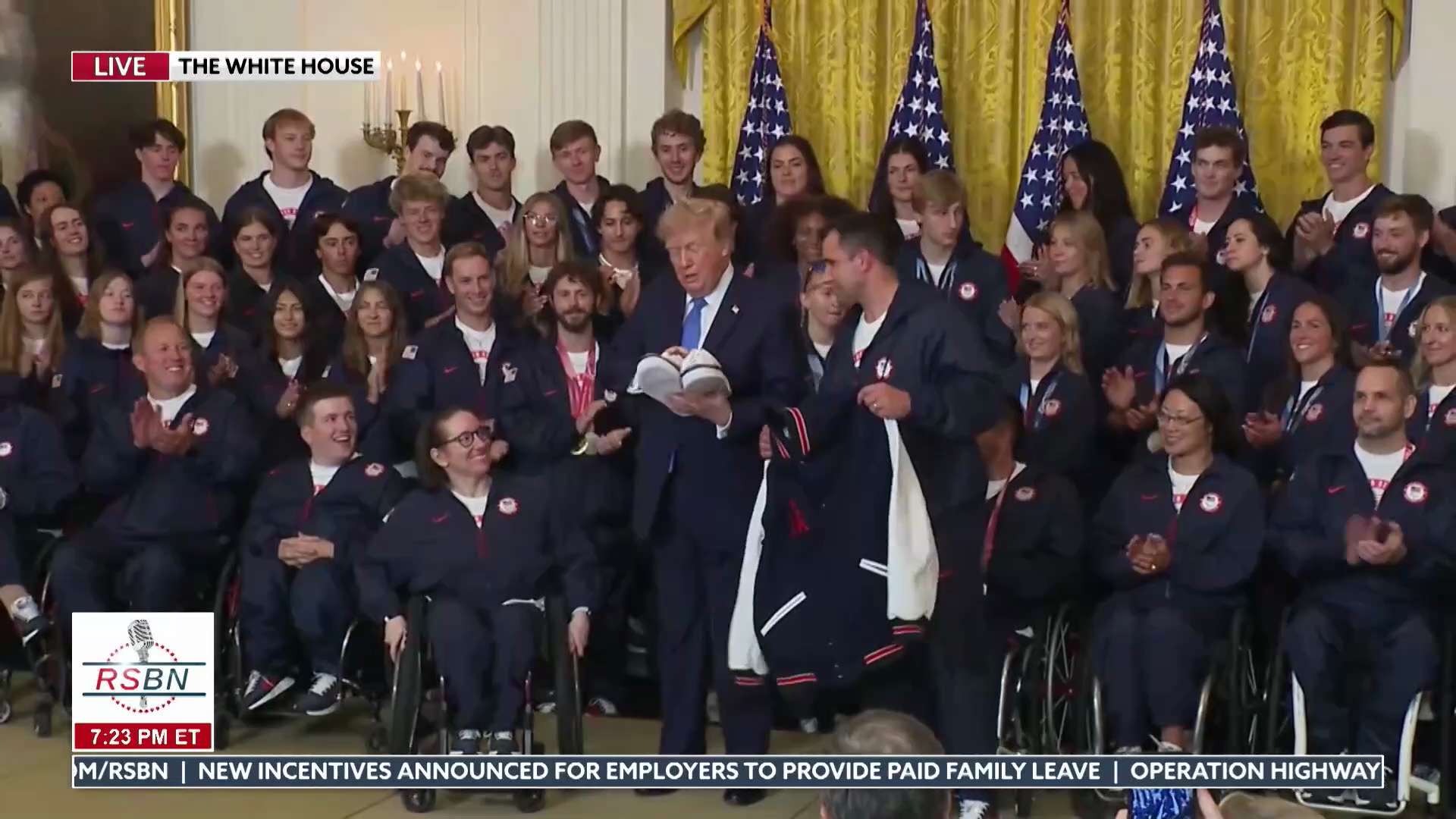 WATCH: President Trump Receives Gifts From Team USA as "USA" Chants Break Out - 08/06/26
