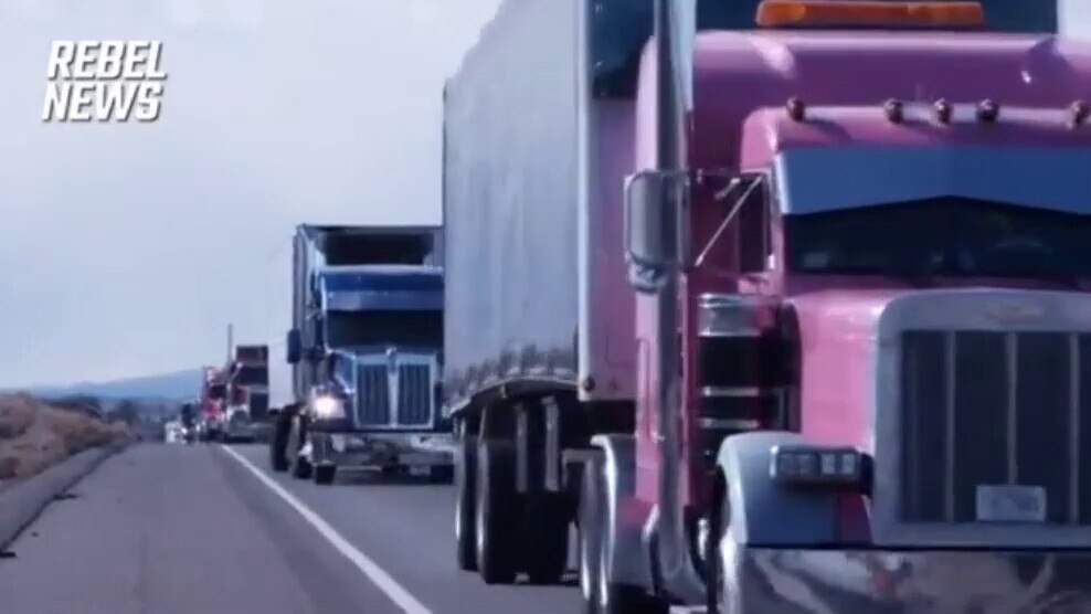 A truck flies the Canadian and U.S. flags as the American Freedom Convoy travels across California’s...
