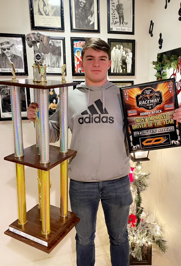  My son with his racing trophies 