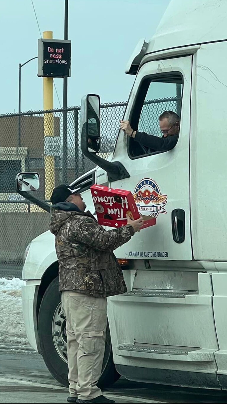 As I passed by the Ambassador Bridge this morning, I saw Michiganders handing out donuts and coffee to truckers waiting for entry to Canada. #canadafreedom
