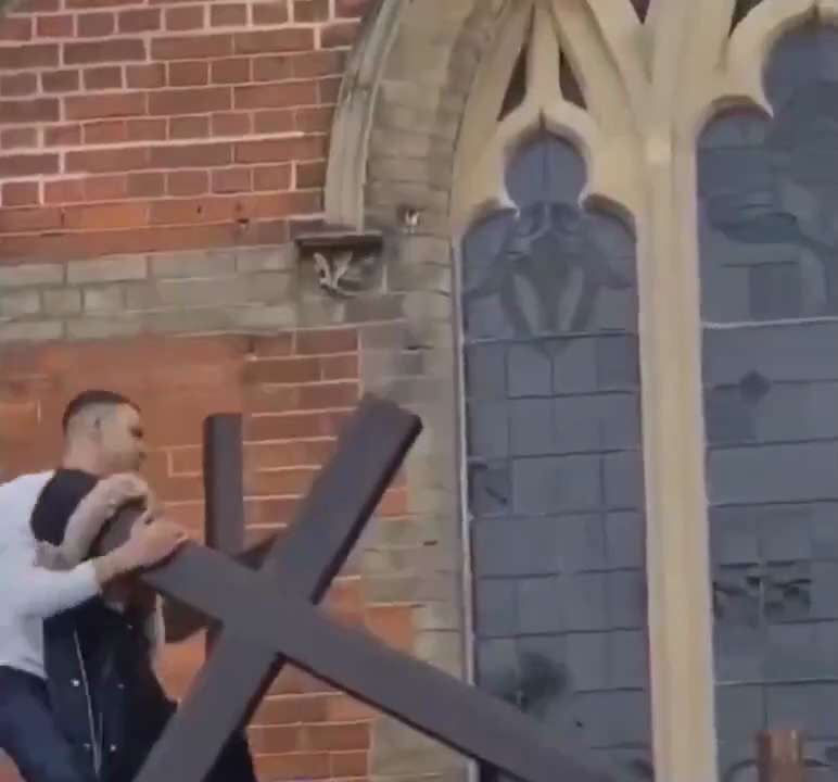 They hate us.
Muslim cultural enricher tears down a cross in a church in UK. 


