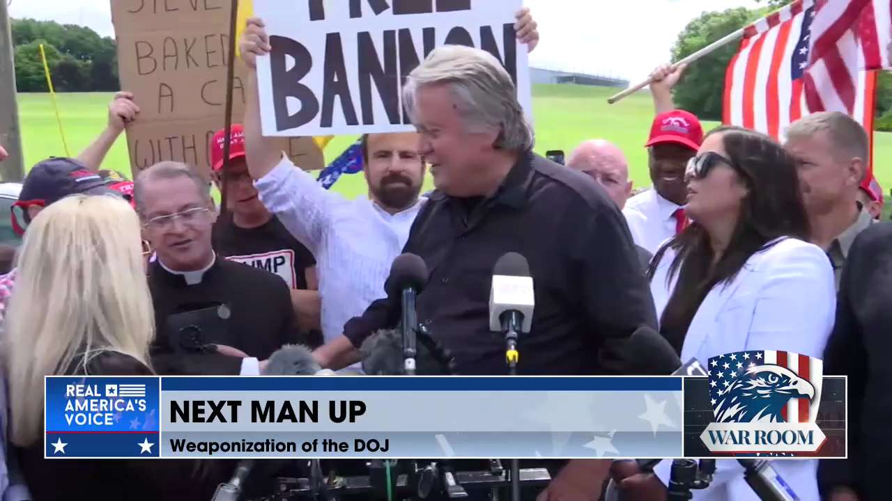 “At a press conference Monday morning, Bannon asks a priest beside him if he'd like to say a few wor...