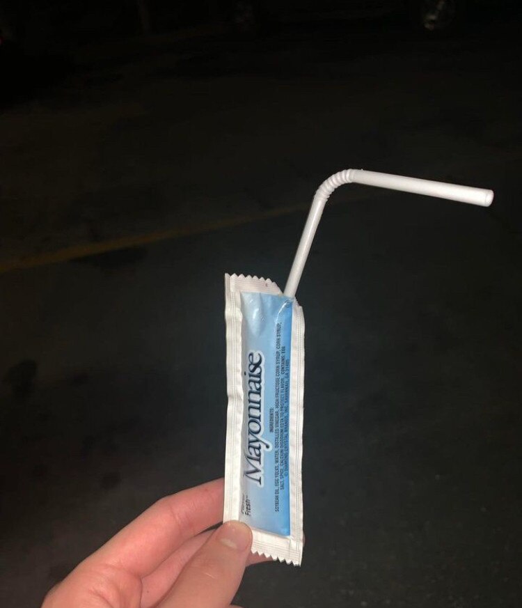 A single‑serve mayo packet being sipped like it’s a gourmet beverage