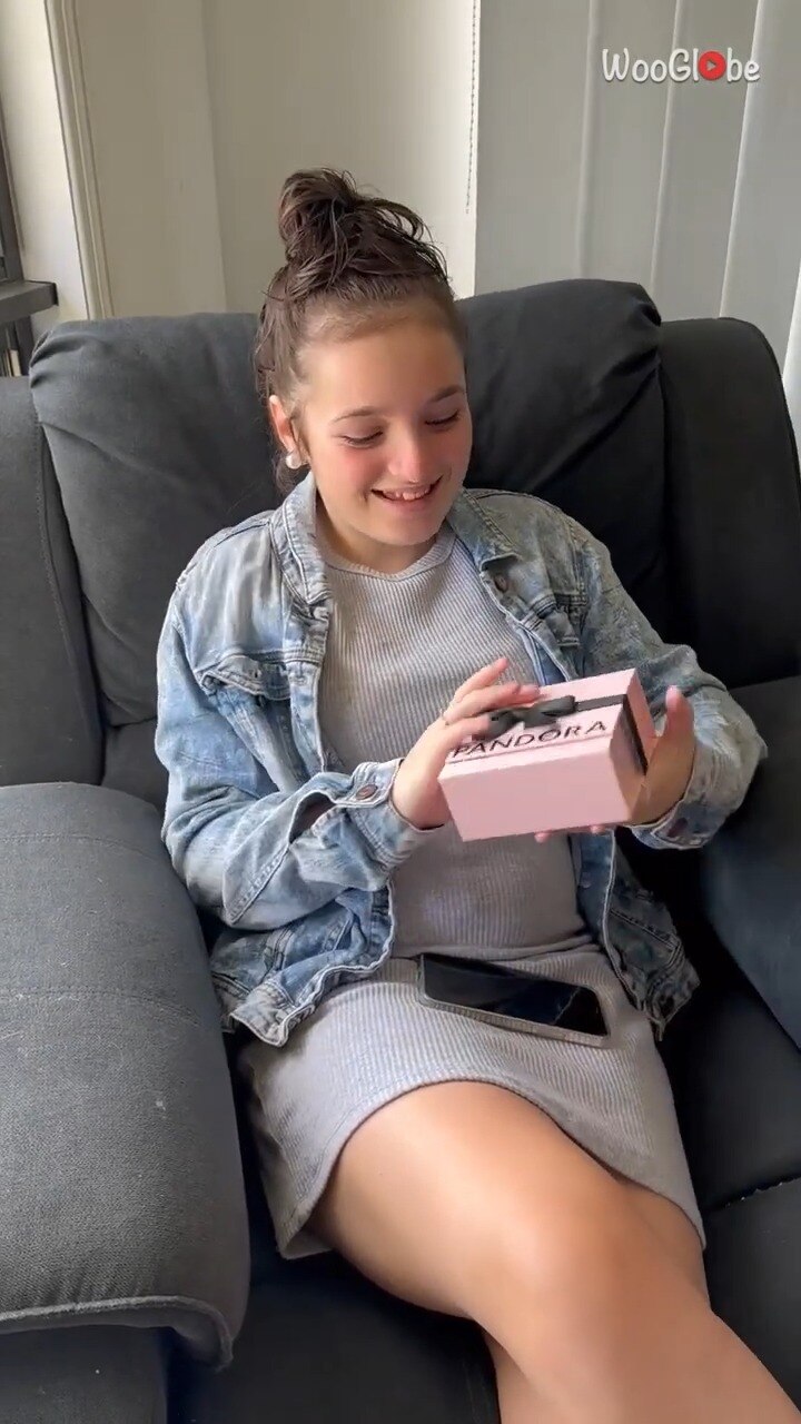 Girl being surprised with a bangle containing her late sister's ashes.
