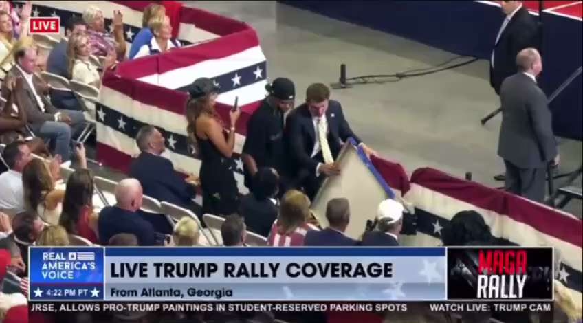 Trump Signs A Fan Painting Of The 'Fight' Scene From The 
Butler, Pa Rally
