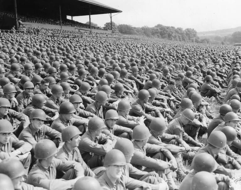 This photo, taken in May 1944, in Cambridge, England, shows thousands of American soldiers attending a Memorial Day service wearing their helmet liners. A 