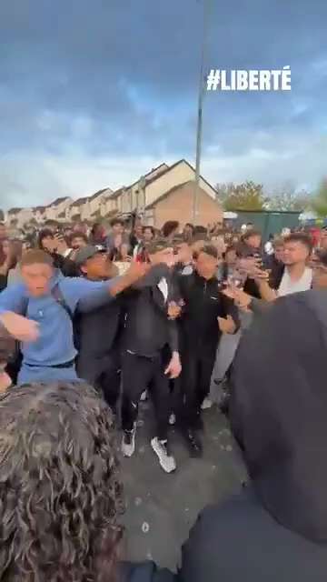 The medieval commune of Beaugency in France, the invader youth rioters singing and dance to a song c...