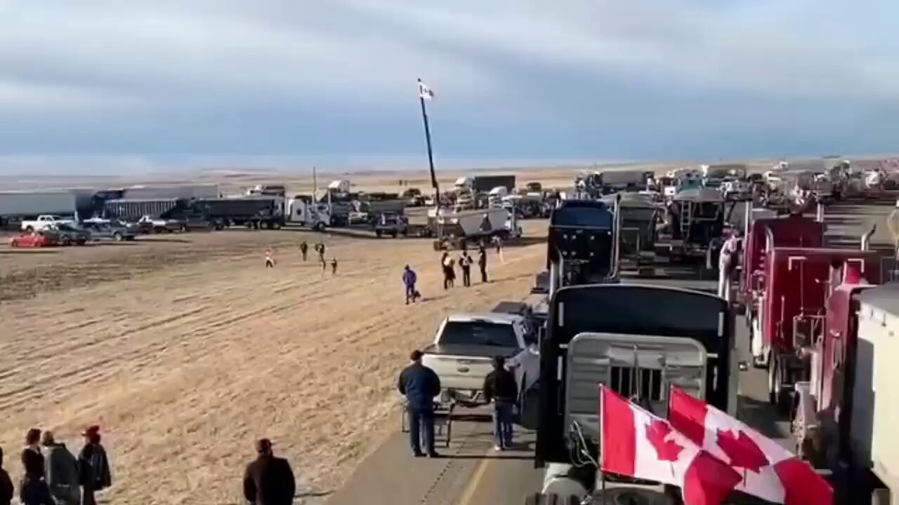 BREAKING: Massive convoy of truckers have blockaded the US-Canada border crossing in Alberta