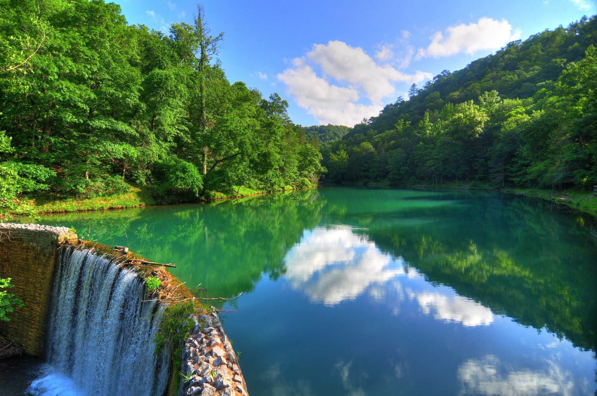 Mirror Lake has a dam that forms a spectacular two-tiered waterfall or the fresh, clear water that g...