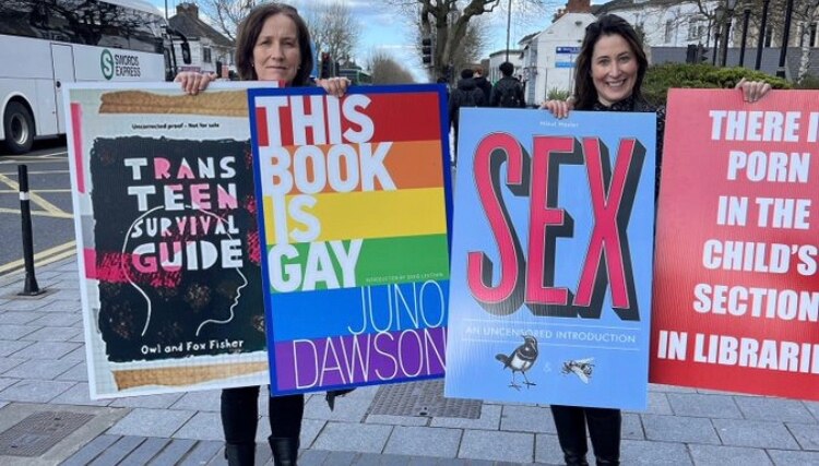 Why does Jana stand in the street advertising these books in this way? Great publicity for the autho...